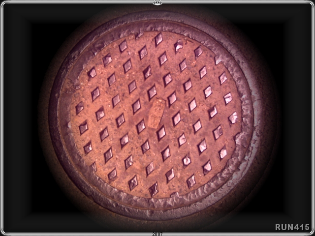 = Manhole Cover =
Recoloured and cropped with sunburst gradient.
I really like metal/industrial shots...
and this came in handy for the main site logo.
(If you look closely at the top logo...
on the previous page...(click this image)
...you can see the diamonds.)